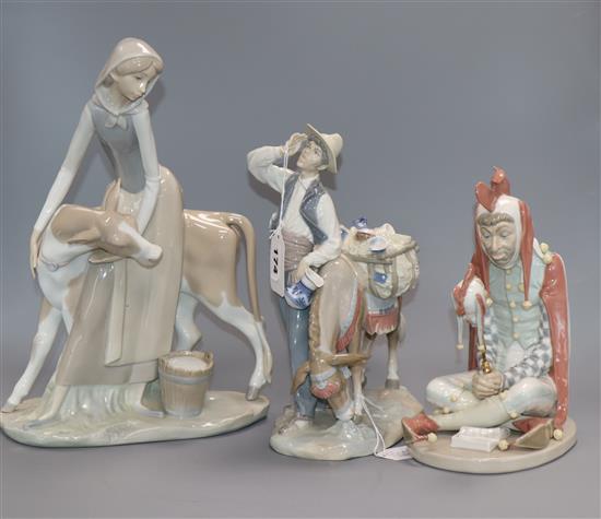 A Lladro figure of a jester, a typical pedlar and a girl with calf tallest 33cm
